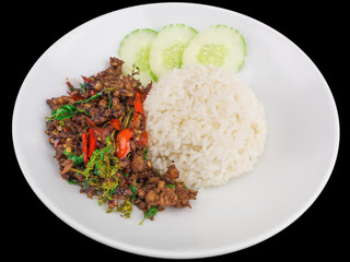 Rice topped with stir fried hot and spicy pork with basil isolated on the black background with clipping path