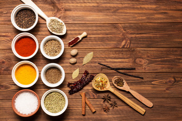 Spices on brown rustic wooden background, soft focus, horizontal

