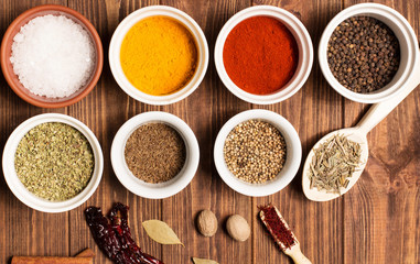 Spices on brown rustic wooden background, soft focus, horizontal
