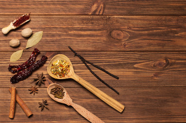 Spices on brown rustic wooden background, soft focus, horizontal
