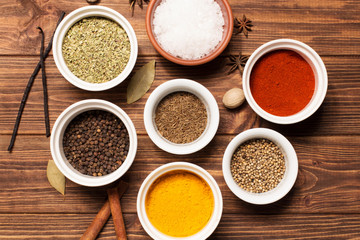 Spices on brown rustic wooden background, soft focus, horizontal
