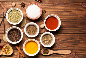 Spices on brown rustic wooden background, soft focus, horizontal
