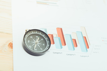 business navigation concept with compass and diagram or graph