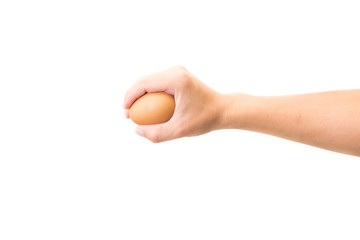 Hand holds a brown egg on a white background