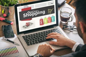 Man working on a laptop - online shopping on the screen
