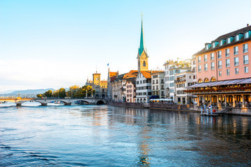 Sunset view on the riverside with beautiful buildings and church tower in Zurich in Switzerland