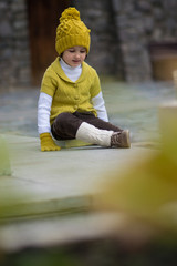 Little fashionable girl in warm clothes