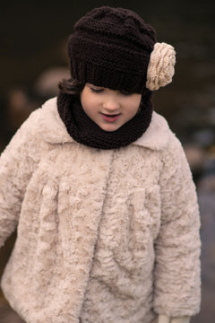 Little fashionable girl in warm clothes
