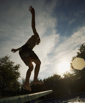 Boy Jumping Off Diving Board