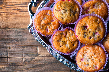 Tasty homemade muffins on silver tray. Top view. Copyspace