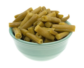 Organic cut green beans in a bowl isolated on a white background.