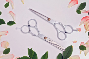Scissors white background. Hairdresser salon concept. Creative arrangement made from flowers and pentals. Haircut accessories