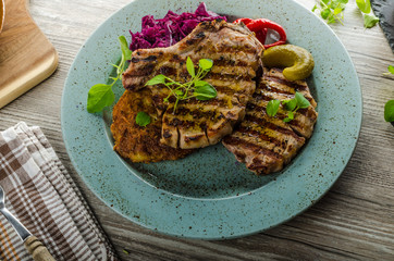 Grilled pork chops with herbs and garlic, potato pancakes