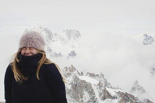 Girl Cringing From The Cold In The Mountains; Chamonix, France