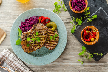 Grilled pork chops with herbs and garlic, potato pancakes