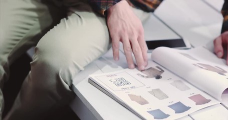 Man scanning qr code advertising with smartphone on clothes catalog modern technology and fashion shopping concept  - Powered by Adobe