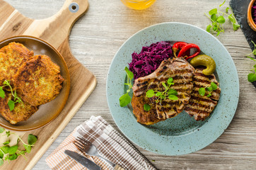 Grilled pork chops with herbs and garlic, potato pancakes