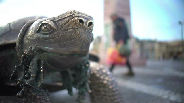 Close-up of turtle sculpture holding bunch of grapes in mouth, Bordeaux, France