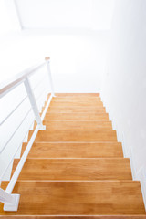 Fototapeta na wymiar The modern wooden stair way in home close up.