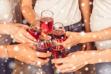 Cheers! Girlfriends having xmas party and drinking red shampagne