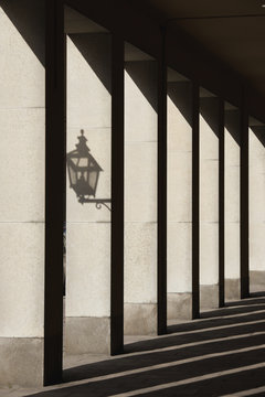 Shadows cast by sunlight shining on pillars and lantern