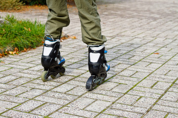 Roller skate legs close up in skatepark. Low section. Roller skates is extreme sport.