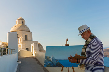 Man paints  sea and Church