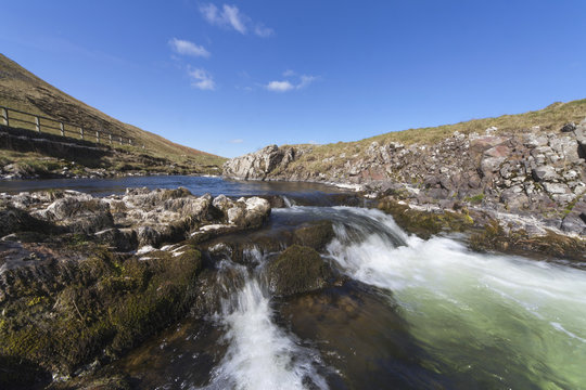 Water Flowing Over Rocks In A River Through The Cheviot Hills; Cheviots, Northumberland, England