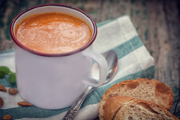 Thanksgiving Pumpkin soup on rustic background 