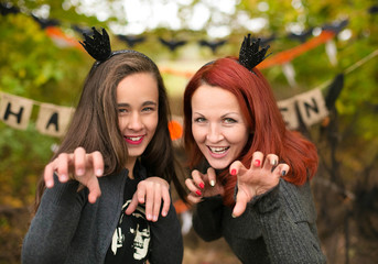 Happy people in halloween costume with jack pumpkin, tick or tre