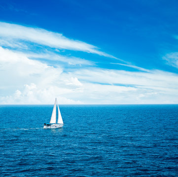 White Yacht Sailing in Blue Sea.
