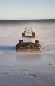Concrete And Wooden Posts Immersed In Water And Mist; Northumberland, England