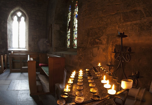 Candles Lit Inside A Church Sanctuary; Bamburgh, Northumberland, England