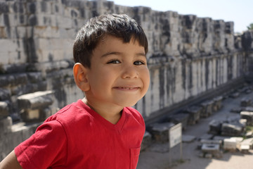 Portrait of smiling boy in the temple of Apollo.