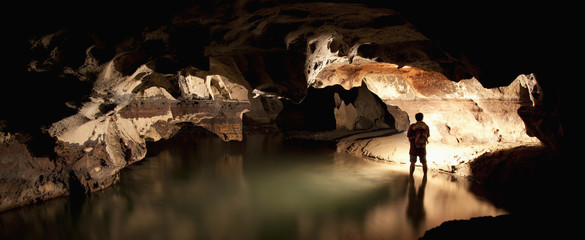 A Filipino Tour Guide Holds A Lantern Inside Sumaging Cave Or Big Cave Near Sagada; Luzon, Philippines