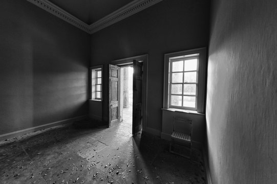 Light Shining Into A Dark Room Through An Open Door; North Yorkshire, England