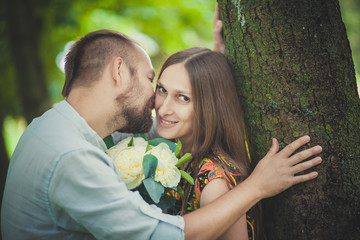 portrait of a man and woman with flowers in nature