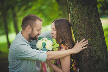 portrait of a man and woman with flowers in nature