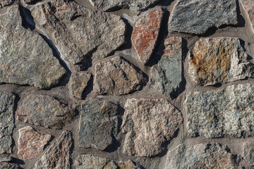 Textures stone background old wall made of pieces of granite