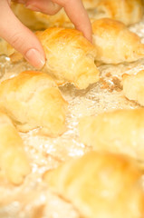 Baked homemade croissants in hand