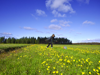 Ball player on green summer field in beekeeper costume. Random fun.