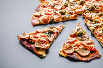 Slice of pizza with cheese and mushrooms on dark mirror background