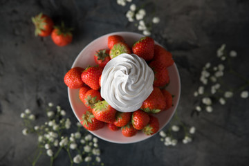 Obraz na płótnie Canvas Fresh strawberries with whipped cream, frozen yogurt on a dark background. Top view.