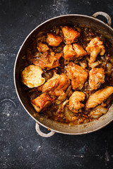 Chicken meat Fried with caramelized sauce. Overhead of braised chicken fry sliced in frying pan. 