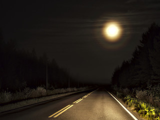 Full moon with halo on dark forest highway. 