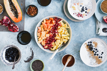 Breakfast table. Chia acai smoothies bowl with seeds, nuts, dates over breakfast table. 
