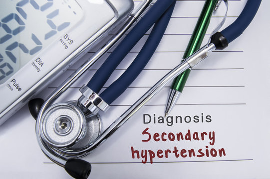 Diagnosis Secondary hypertension. Stethoscope and electronic sphygmomanometer lie on medical paper form with cardiac diagnosis Secondary hypertension related to group hypertensive diseases