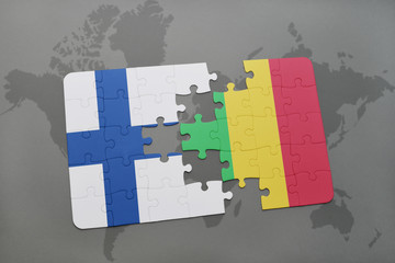 puzzle with the national flag of finland and mali on a world map background.