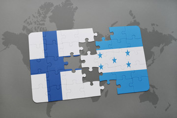 puzzle with the national flag of finland and honduras on a world map background.