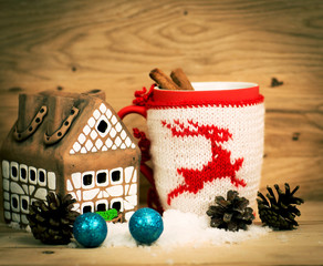 Mug Of Tea Or Coffee. Gift with red ribbon and . Sweets And Spices. Christmas Decorations. Wooden Background.